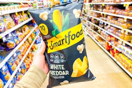 hand holding a bag of smartfood popcorn