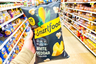 hand holding a bag of smartfood popcorn