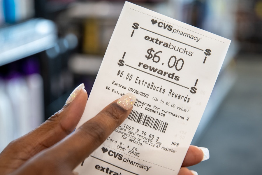 Someone pointing to the expiration date on a CVS Rewards receipt