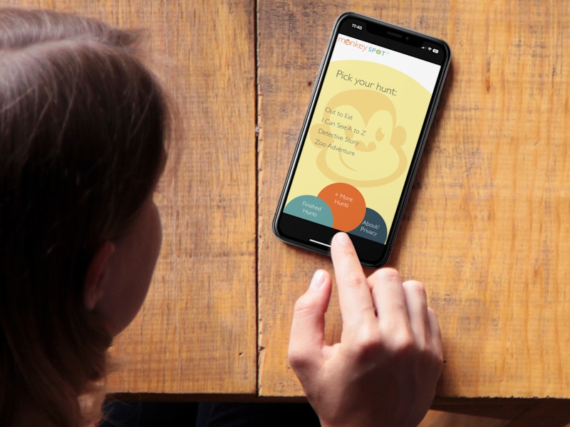 Someone using the Monkey Spot Scavenger Hunt app on a phone