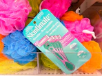 schick skintimate razors sitting on top of bath loofahs at target