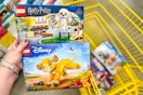 hand holding harry potter and simba lego sets