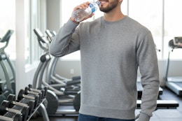 a man wearing a sweatshirt in the gym
