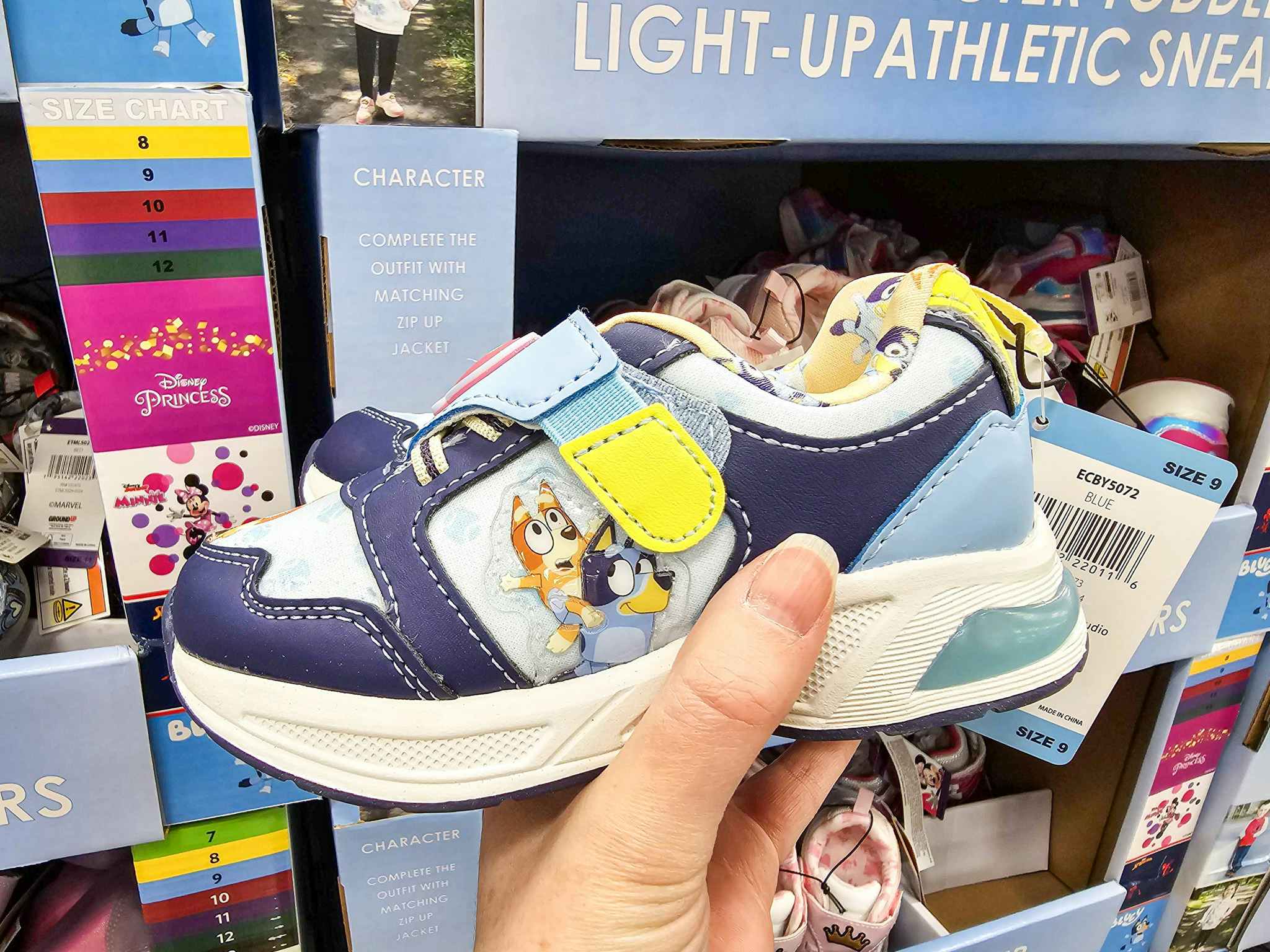 person holding a bluey light up kids sneaker