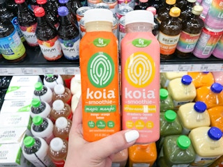 hand holding two bottles of koia smoothies at target