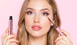 a person putting on eyelash serum