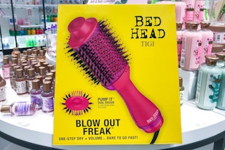 A Bed Head Blow Out Freak One-Step Hair Dryer in its box on a display at Target.