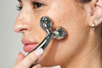 woman using a face roller