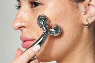 woman using a face roller