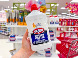 hand holding a bottle of kingsford charcoal lighter fluid at target