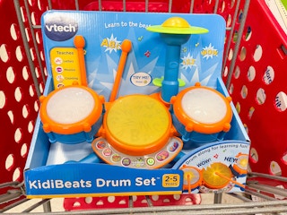 A Vtech drum set sitting in a store cart