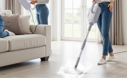 a person cleaning a floor with a steam cleaner 