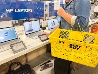 someone looking at laptops