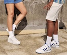 A man and woman wearing Adidas shoes and socks.