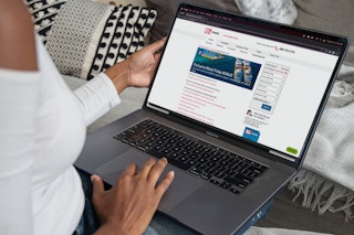 Woman in a white shirt shopping online on BJ's Wholesale website