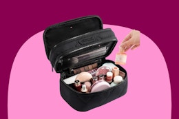 Makeup and toiletry bag in black quilted fabric with two zippered tiers and pockets and elastic within them