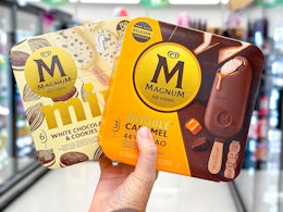 hand holding two boxes of magnum bars