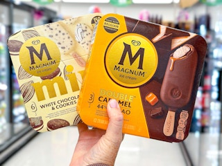 hand holding two boxes of magnum bars