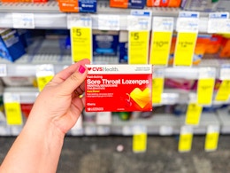 hand holding cvs health sore throat lozenges