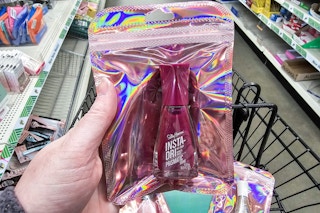 person holding a pink bag with a sally hansen nail polish in it