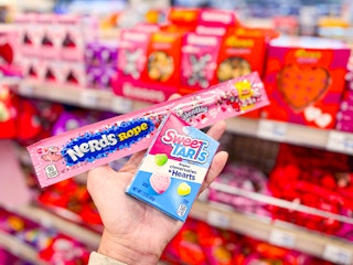 person holding a nerds rope and sweetarts candy