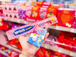 person holding a nerds rope and sweetarts candy