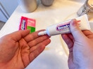 person applying Benadryl to hand