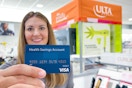 someone holding an HSA card in Ulta