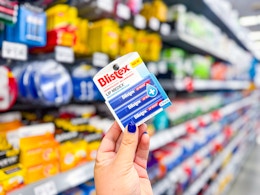hand holding blistex lip balm in walmart aisle