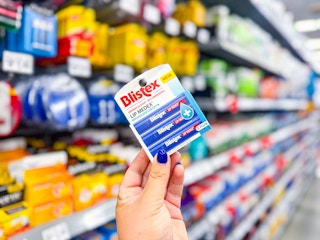 hand holding blistex lip balm in walmart aisle