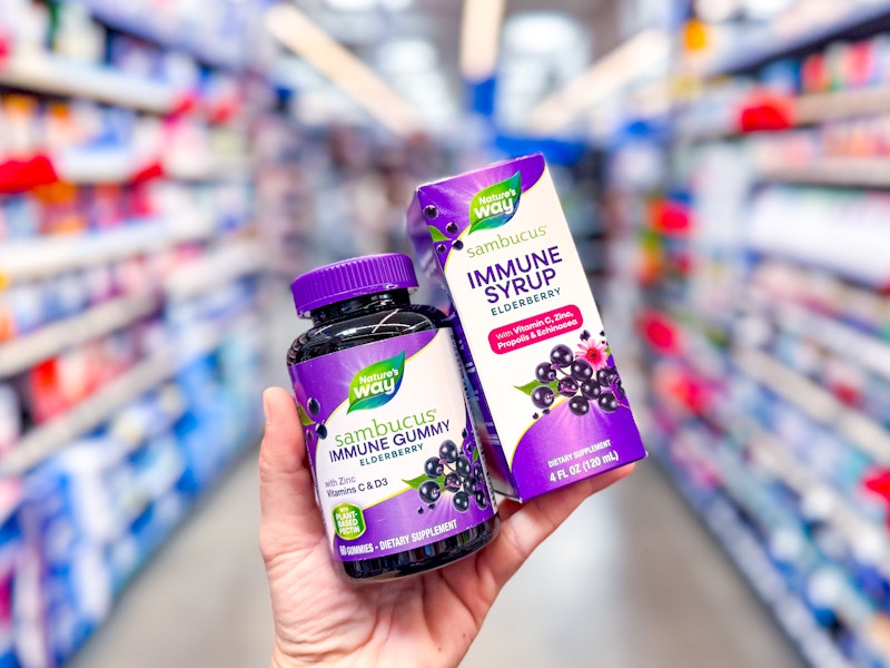 hand holding natures way sambucus immune syrup and gummies in walmart aisle