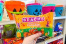 hand holding brachs candy corn