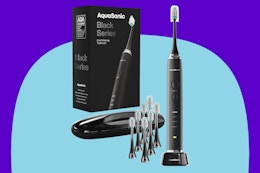 Aquasonic Black Series Ultra Whitening Toothbrush on a blue background.