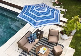 An aerial shot of a blue-and-white striped umbrella on a patio