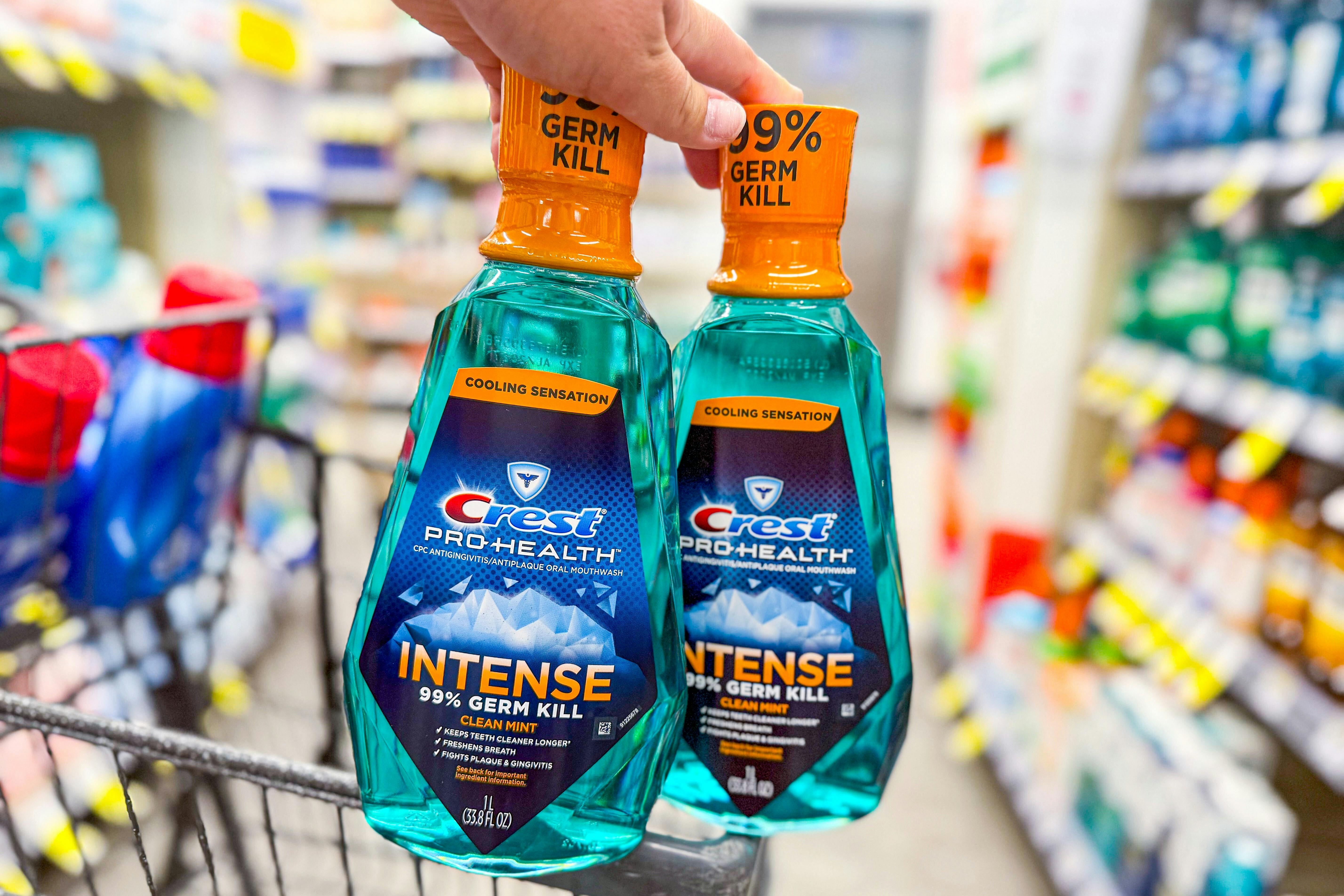 hand holding two crest intense moutwashes