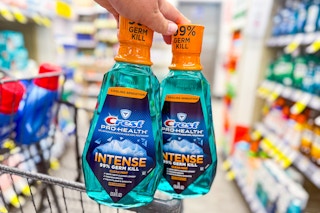 2 bottles of crest mouthwash on a cart