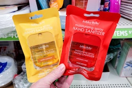 hand holding two ashley belle hand sanitizers