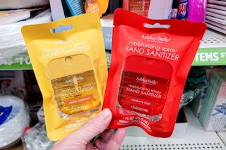hand holding two ashley belle hand sanitizers