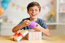 Boy holding a purple squishy dumpling toy in his hand 