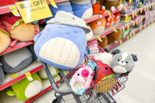 squishmallows in a shopping cart with 80% off signs