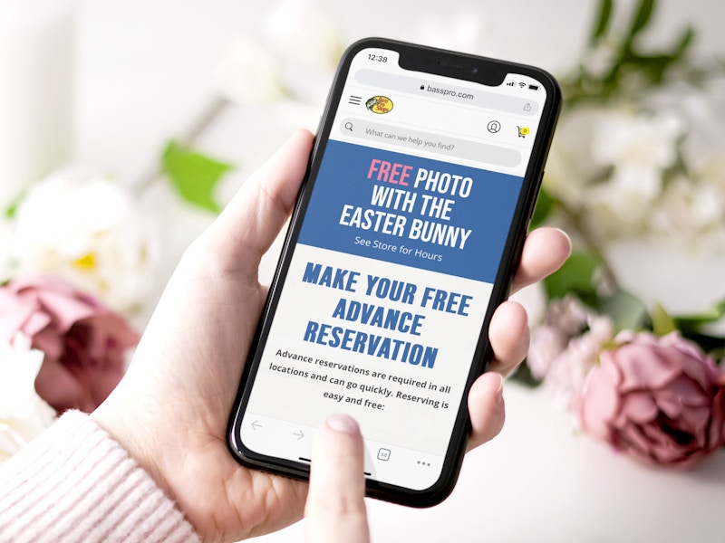 person on phone reserving easter bunny photos at bass pro shops