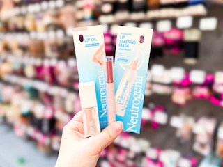 hand holding three neutrogena lip cosmetics