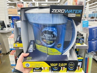 A ZeroWater 10-Cup Ready Pour Pitcher being held up in an aisle at Bed Bath & Beyond.