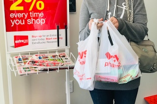 a person holding up cvs bags in a cvs