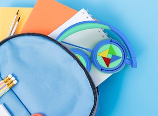 blue and green kids headphones in a backpack