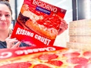 person holding up a DiGiorno Rising Crust pizza