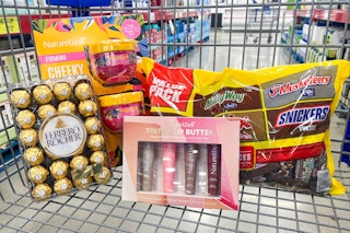 ferrero rocher chocolates, a bag of mars candy, body butter, and lip butter in a cart
