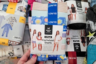 person holding a 3-pack of kids cartwheel shorts