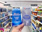 hand holding crest pen and whitening kit in walgreens