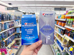 hand holding crest pen and whitening kit in walgreens